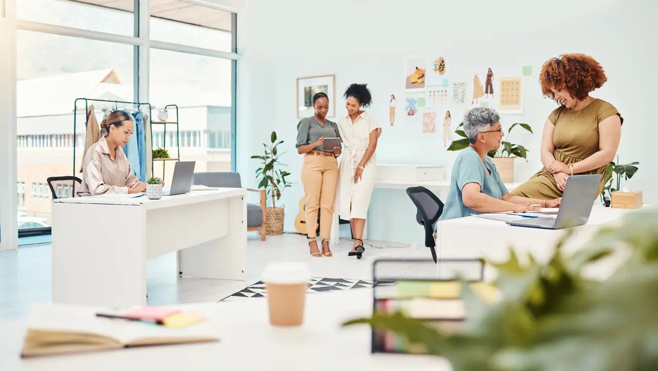 Two designers reviewing work together in a bright studio